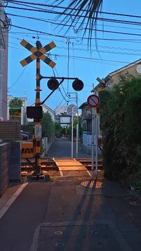 Japanese Railroad Crossing in Residential Street at Sunset