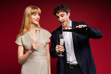Elegant couple celebrating, drinking sparkling wine from glasses
