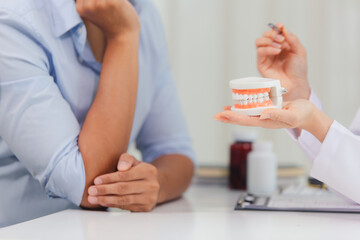 Fototapeta premium A man with a toothache saw a dentist at the clinic. To take care of his teeth and the dentist has advised him on how to care for and maintain his teeth. Dental treatment and diagnosis concepts
