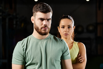 Fototapeta premium Male trainer demonstrates self-defense techniques to a woman in a gym.