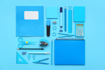 Composition with notebooks and different stationery on blue background
