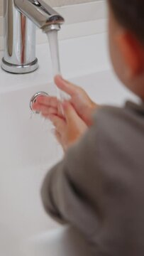 boy and baby child in bathroom,brushing teeth,washing hands with soap,combing hair.siblings,brothers in front of sink on tabouret chair.kids on toilet with lot of paper.