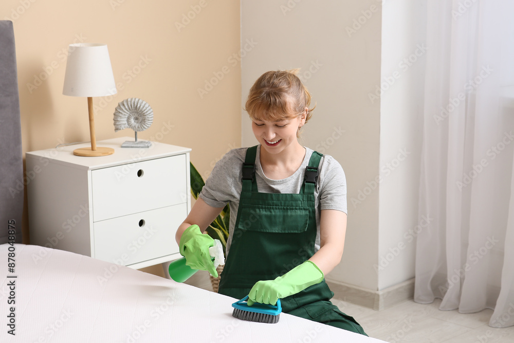 Canvas Prints Female janitor cleaning mattress with brush and detergent in bedroom