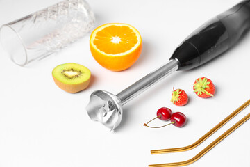 Hand blender and different ingredients for preparing fresh smoothie on white background