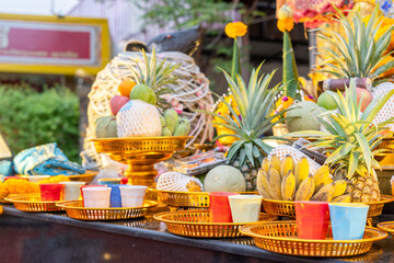 Offerings of bananas, pineapples, and milk in plastic cups that Buddhists bring to offer to the highly revered Lord Ganesha, enshrined at the Bang Yai Temple, Nonthaburi, Thailand.