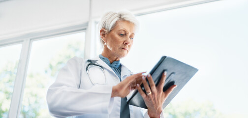Hospital, mature doctor and tablet for research on medical treatment, cure and scroll online....