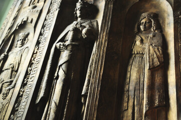 Bas-relief sculptures in a Catholic church depicting sacred figures of a king and queen majestic