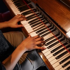 Fototapeta premium Piano Player - Playing the Piano during Concert or Christmas - Romantic Playing of the Piano - Black Grand Piano during a Performance - Classical Instrument in a Orchestra - Closeup of the Player Hand