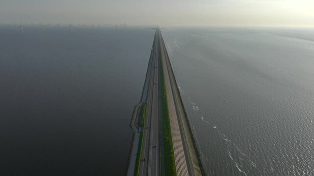 Afsluitdijk construction on pumping stations, new sluices and A7 Highway in Northern Netherlands. Long Road in the Sea.