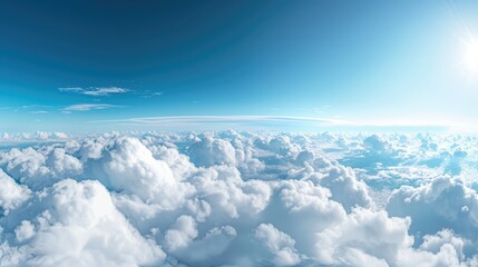 Fototapeta premium Above the Clouds: Panoramic view showcasing the fluffy, cumulus clouds against a clear, azure sky, with the bright sun shining.