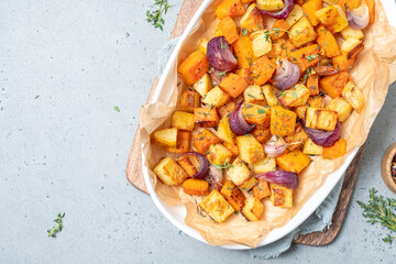 A white plate with a variety of vegetables including onions and potatoes