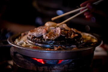 hot pan grill and soup on charcoal stove