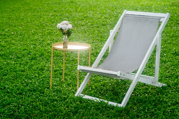 sea chairs on green grass in the summer during the daytime