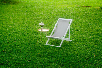 sea chairs on green grass in the summer during the daytime