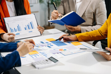Businessman and team analyzing financial statement Finance task. with smart phone and laptop and ...
