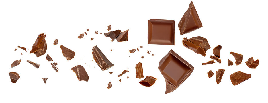 &nbsp;Levitating milk chocolate chunks isolated on white background. Broken chocolate bar pieces and cocoa crumbs explotion  on white background. Chocolate collection.