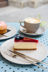 Two cups of cappuccino with desserts on the table in a sidewalk cafe.