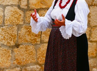 Woman in traditional ethnic costume in dalmatian street