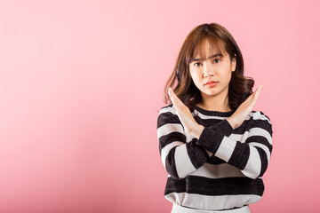Portrait Asian beautiful young woman unhappy or confident standing wear holding two cross arms say...