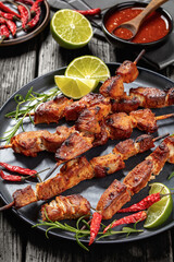 roasted juicy pork kebabs on plate, top view