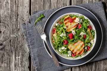 grilled pear salad with cheese, arugula, berries