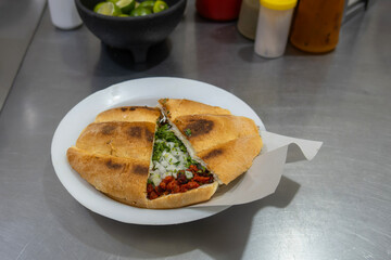 Delicious Mexican Torta de Carne de Pastor Served on White Plate