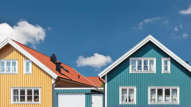 Horizontal pan of colorful old swedish houses in Karlskrona in front of a blue sky