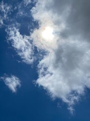 Obraz premium Clean blue sky. The sun is breaking through the cloud