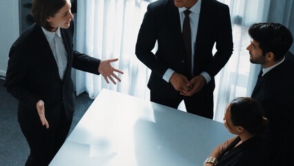 Top view of project manager looking at meeting table surrounded by diverse business people brainstorm and planning strategy. Group of smart people discussing and solve business problems. Directorate.
