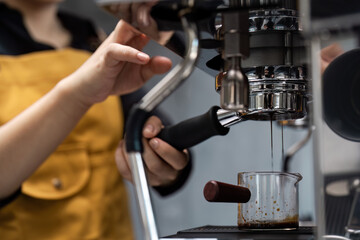 Barista Preparing Fresh Espresso with Professional Coffee Machine in Modern Cafe