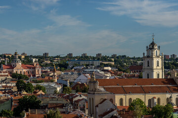 Beautiful view over a part of Vilnius in Lithuania surrounded by forest during a sunny day in...