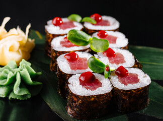 Gourmet tuna sushi rolls on elegant black plate