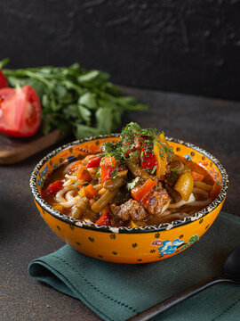 Delicious lagman soup, uzbek lagman soup, Asian cuisine, lagman soup with meat and vegetables. Lagman soup with beef, noodles, sweet peppers, onions and herbs.