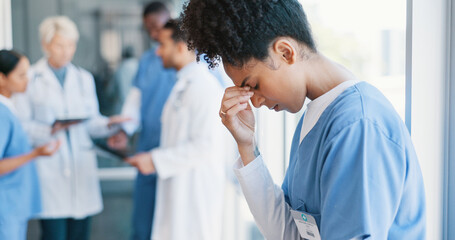 African woman, nurse and headache in burnout, grief or mistake against glass window in hospital...