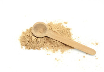 heap of maca powder in a wooden spoon isolated on white background