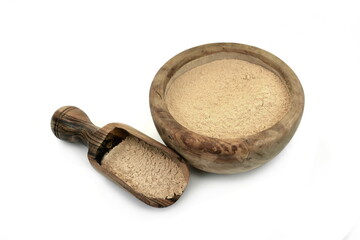 Maca powder in wooden bowl with scoop isolated on white background
