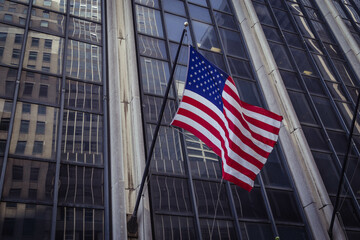 American Flag Flying from the side of a New York Building