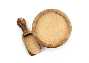 Maca powder in wooden bowl with scoop isolated on white background