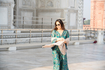 Agra, India, March 23, 2024. Portrait of an Asian woman with the Taj Mahal in the background.