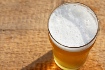 Craft beer in pint glass on a wooden surface