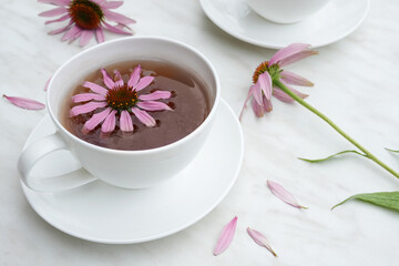 Homemade herbal tea. A remedy that boosts immunity and relieves stress. White cups with a hot healthy drink. Side view. Copy space. 