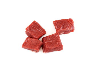 Pile of beef cubes isolated on white. raw diced beef meat ready for goulash. cubes of meat streaked with fat