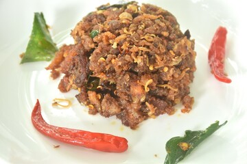 spicy fried chop fermenting fish with herb and chili on plate