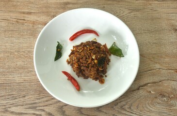 spicy fried chop fermenting fish with herb and chili on plate