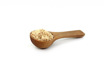 Shelled and ground Ground, milled, crushed almond nuts in a wooden spoon isolated on white. Edible, dried, brown seeds of Prunus dulcis. Ingredient in marzipan, nougat, cookies.