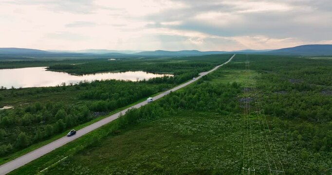 Drone following a RV driving in boreal wilderness, summer day in Enontekio, Finland