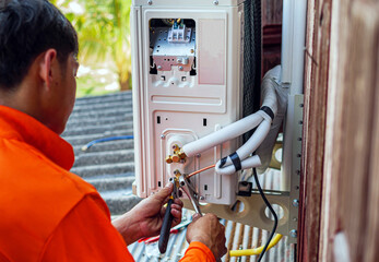 Air conditioning technicians install new compressor air in homes, Repairman fix air conditioning...