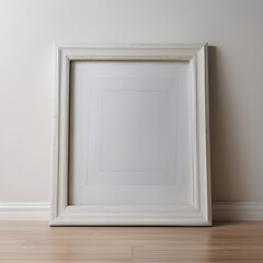 Empty White Picture Frame Leaning on Light Wood Floor