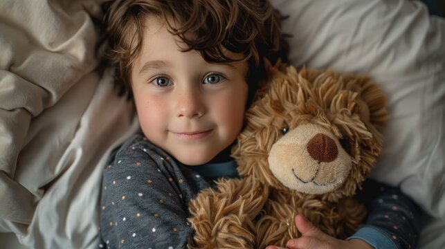 A cute child in pajamas, hugging a stuffed animal and getting ready for bedtime stories