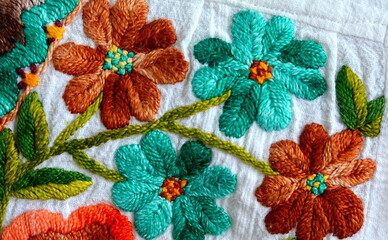 Embroidered flowers on natural white fabric, Serbian folk embroidery.